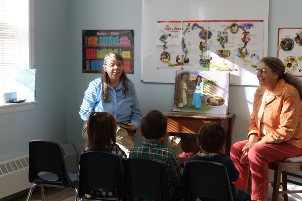 Teachers leading a Sunday School lesson for young children