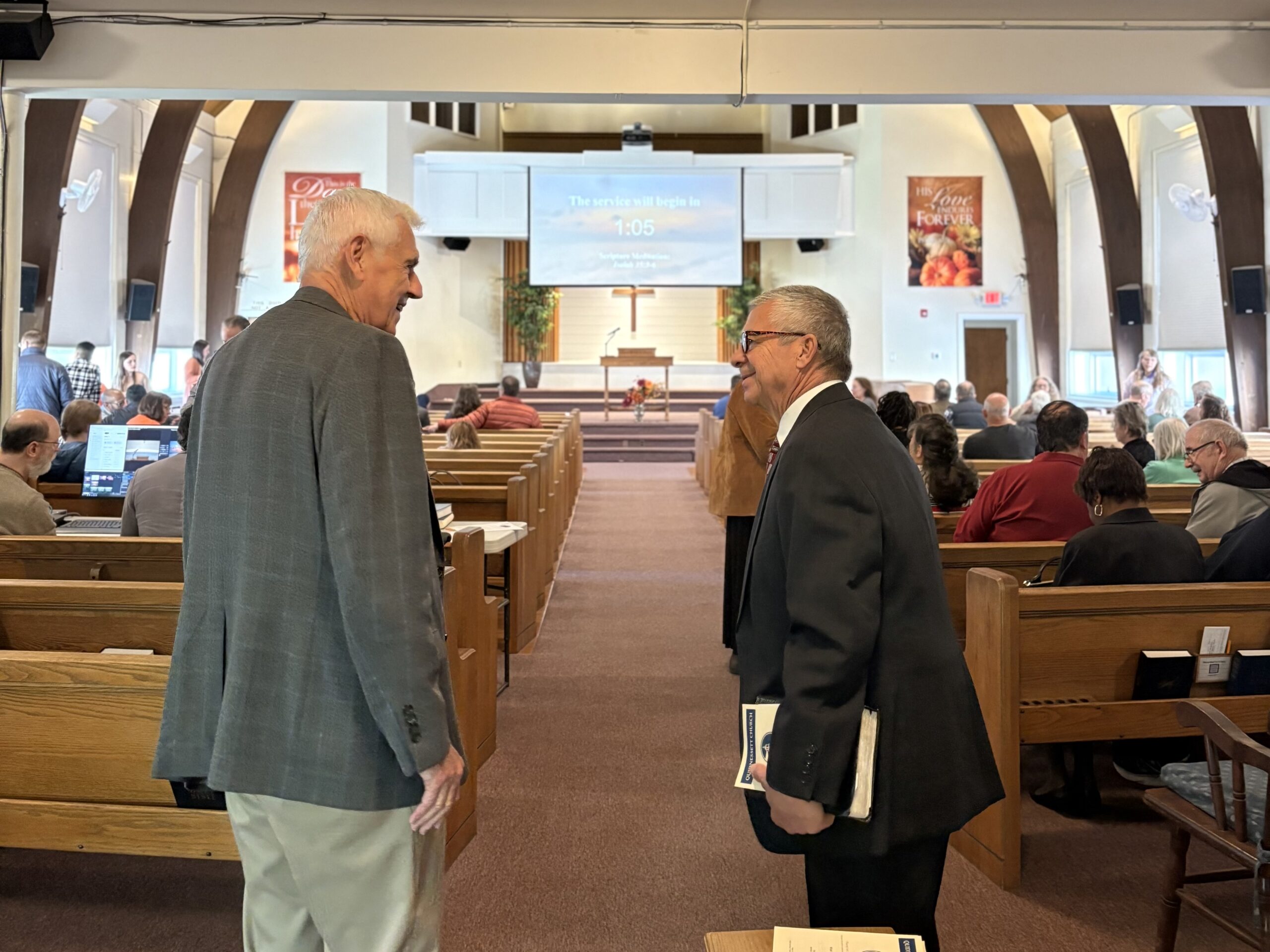 Two members greeting each other in the sanctuary