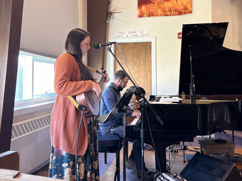 Musicians leading worship on guitar and piano