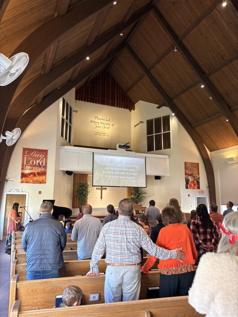 Worshipers standing in the pews during the service